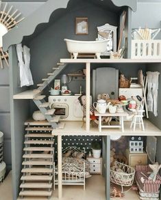 a doll house with stairs and furniture inside