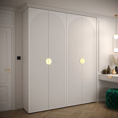 a white closet with two doors and three lights on the wall next to a mirror