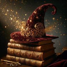 a wizard's hat sitting on top of two books with gold stars in the background