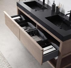 a bathroom vanity with two sinks and an open drawer in the bottom section is shown