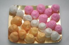 there are many different types of candies on the square plate, all in pink and white