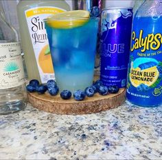 blueberries, lemonade, and water are on the counter next to each other