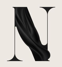 the letter n is made up of black fabric and it looks like an art piece