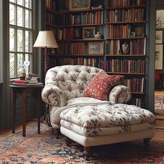 a chair and ottoman in front of a bookshelf