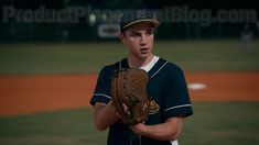 a baseball player holding a catchers mitt on top of a field at night