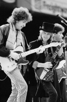 the rolling stones performing on stage with their guitars