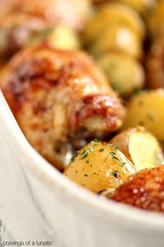 a close up of a bowl of food with chicken and potatoes