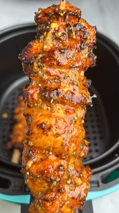 the meat is being cooked on the skewer