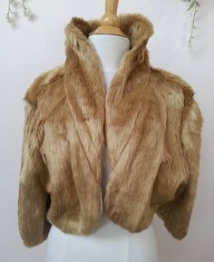 a white mannequin with a brown fur coat on it