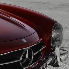 the front end of a red mercedes benz car