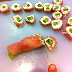 someone is cutting up some food on a table with a knife to cut it into small pieces