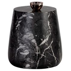 a black and white marble vase sitting on top of a table