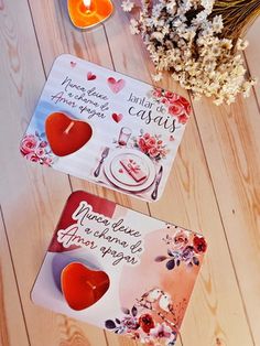 two coasters with hearts on them sitting next to flowers