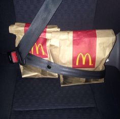 a bag that is sitting in the back seat of a car with mcdonald's on it