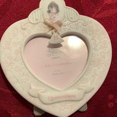 a white heart shaped plate with an angel on it