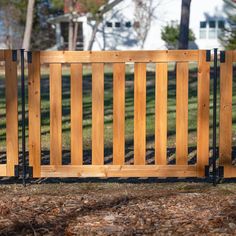 a wooden fence in front of a house