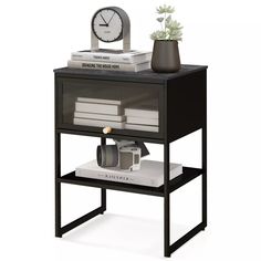 a shelf with books and a clock on top of it next to a vase filled with flowers