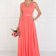 a woman in a coral colored dress holding a bouquet and posing for the camera with her hands on her hips