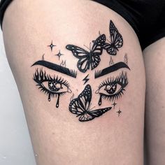 a woman's thigh with butterflies and eye lashes on her thighs, as well as the eyes