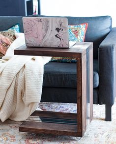 a couch and table with a laptop on it