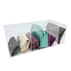 four different purses are in a clear box