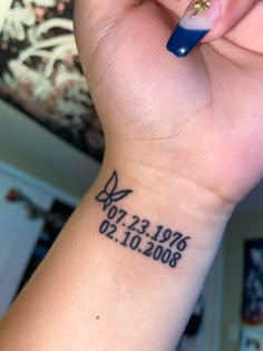 a woman's wrist with a tattoo on it that reads, date and time