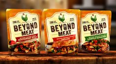 three bags of beyond meat sitting on top of a wooden table