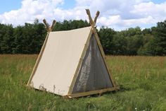 a teepee sitting in the middle of a field