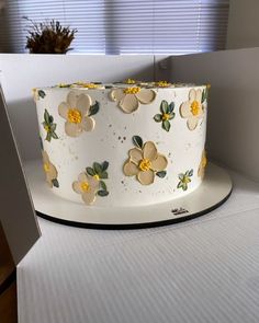 a white cake with yellow flowers on it