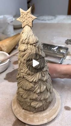 a clay christmas tree sitting on top of a table