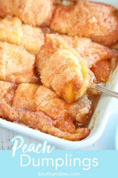 peach dumplings in a casserole dish with a spoon