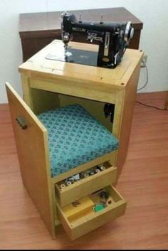 a sewing machine sitting on top of a wooden cabinet