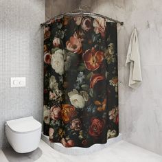 a bathroom with a floral shower curtain next to a toilet