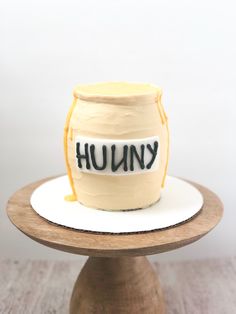 a cake with the word humong written on it is sitting on a wooden stand