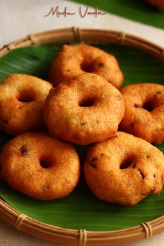 small donuts on a green plate sitting on a table