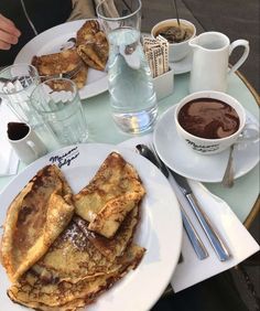 some pancakes and coffee on a table