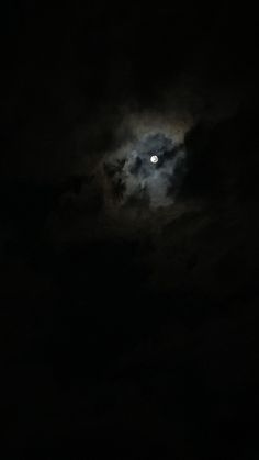 the moon is shining brightly in the dark sky