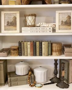 some books and other items on a white shelf