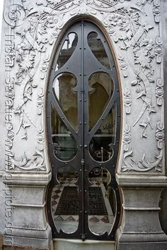 an ornate iron door with decorative carvings on it