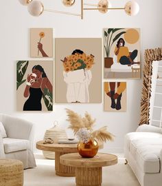 a living room filled with white furniture and paintings on the wall above it's coffee table