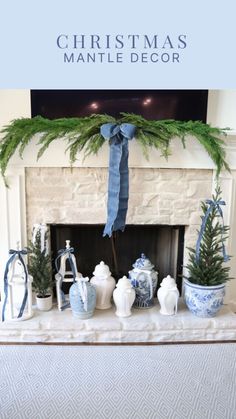 a mantel decorated for christmas with blue and white decorations on it, including potted trees