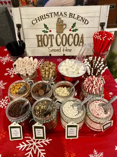 a table topped with lots of candy and candies next to a sign that says christmas blend hot cocoa