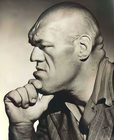 an old black and white photo of a man with his chin resting on his hand