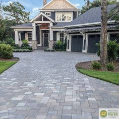 a brick driveway leading to a large house