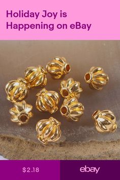 gold plated beads are sitting on a rock