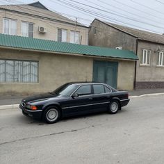 a black car parked in front of a building