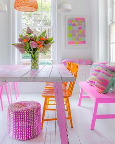 a dining room with bright colored chairs and tables