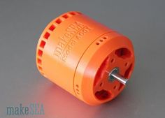 an orange motor on a gray surface with the words maker's sea printed on it