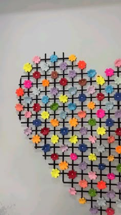 a heart made out of colorful flowers on a wall