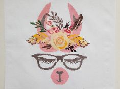 a cross - stitch pattern with glasses and flowers on the face of a bunny wearing eyeglasses